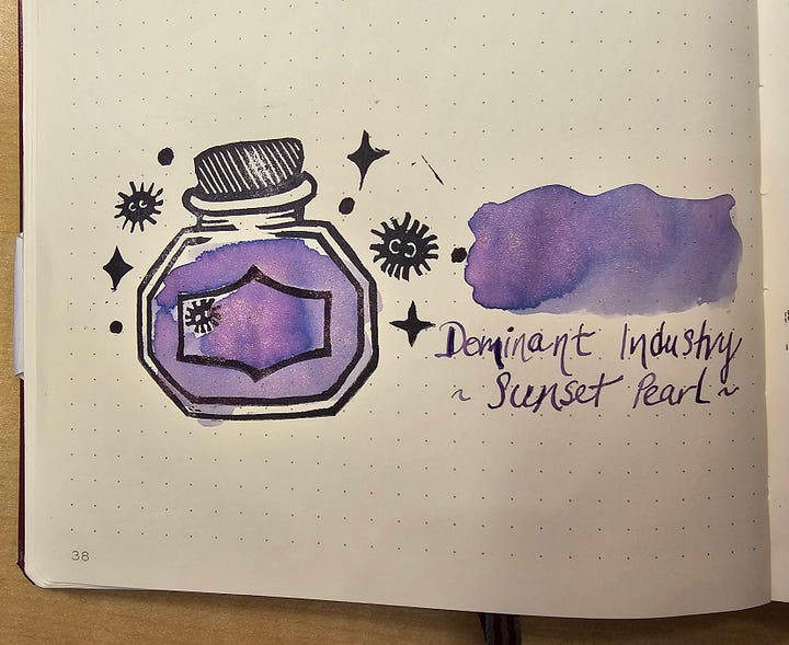 Four photos of a custom made stamp featuring an ink bottle, soot sprites, and sparkles.
