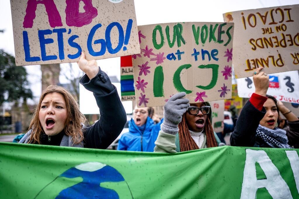Protesters in The Hague, Netherlands, as the ICJ delivers a historic climate ruling, on 23 July 2025.