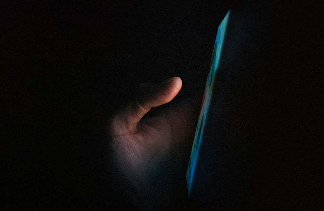 person holding blue light in dark room person holding blue light in dark room