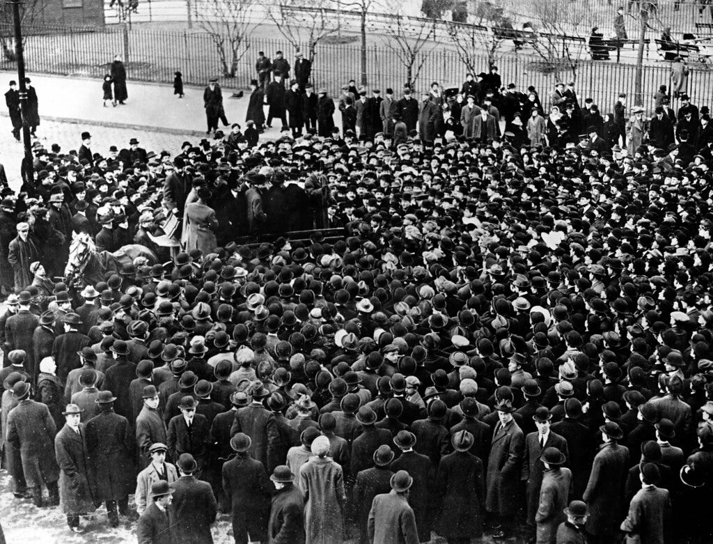 A crowd gathered around a man speaking from the back of a … | Flickr