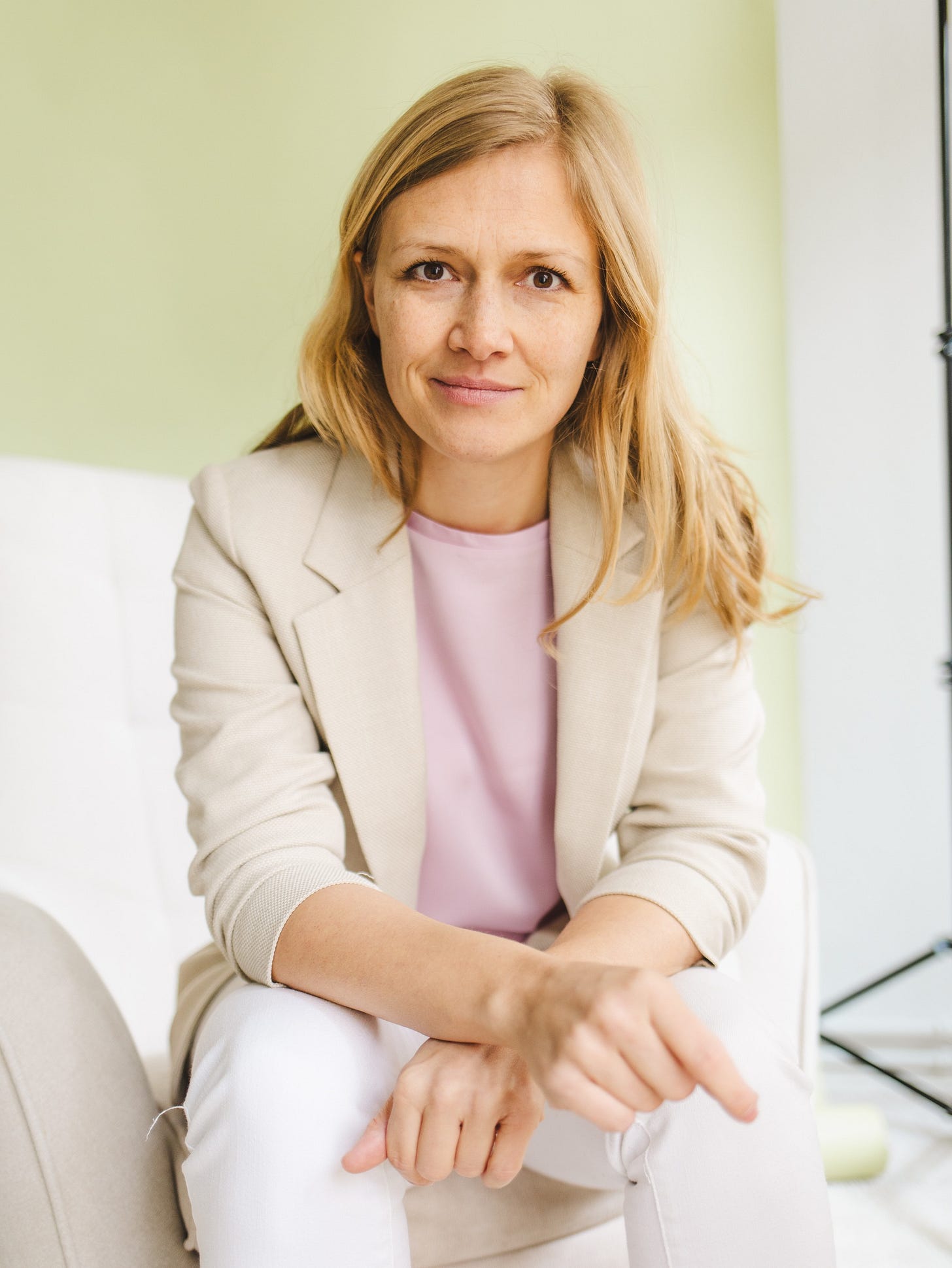 Isabell Prophet sitzt in einem Sessel und schaut in die Kamera.