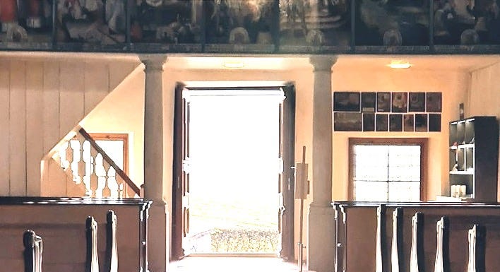 a long hallway with a chandelier hanging from the ceiling