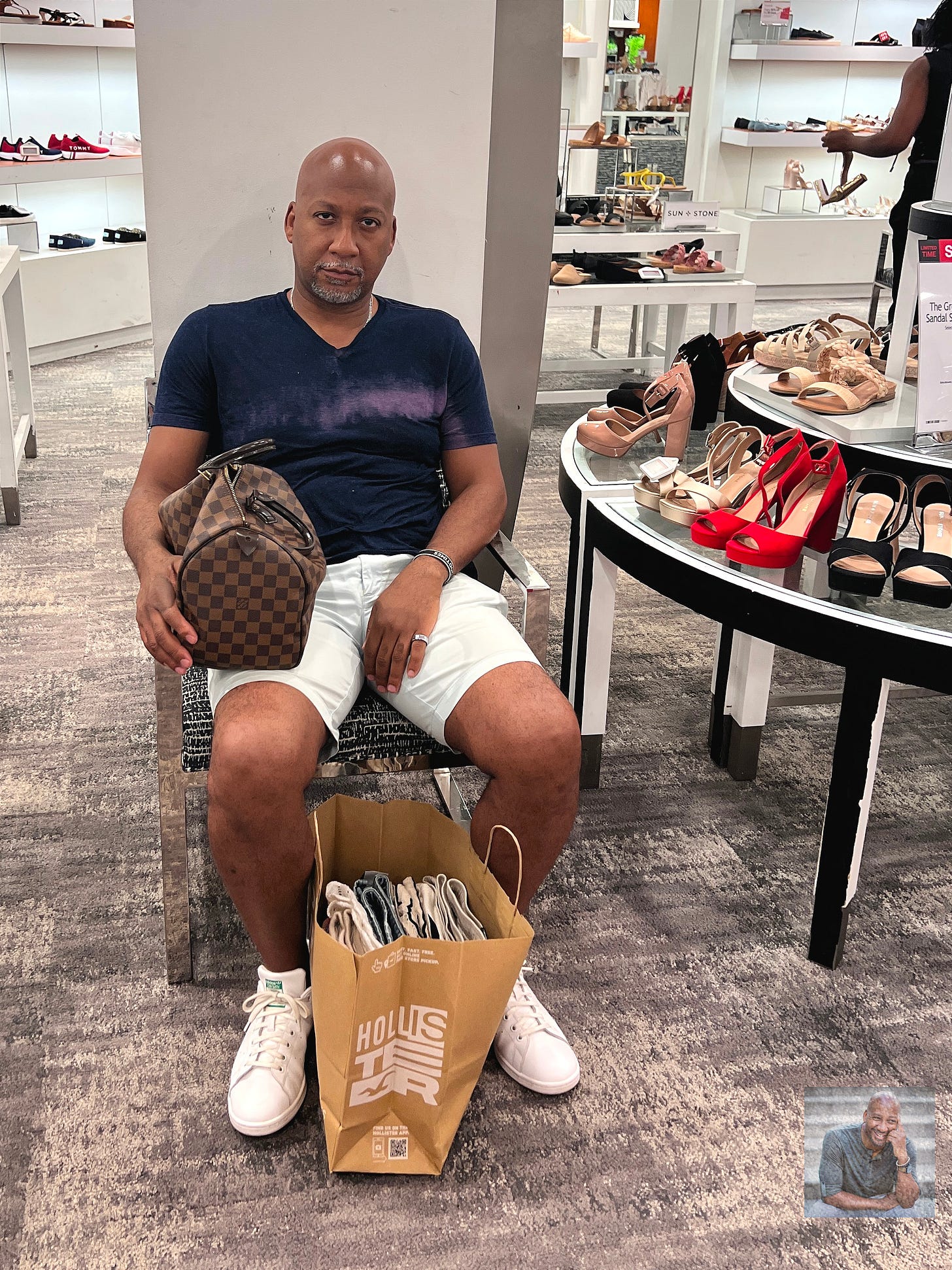 Eric Payne sitting in a women's shoe department at a department store looking exasperated and beaten.