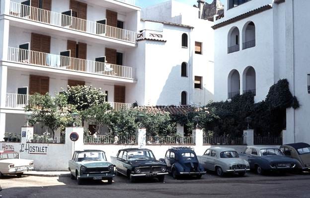 A group of cars parked in front of a white building

AI-generated content may be incorrect.