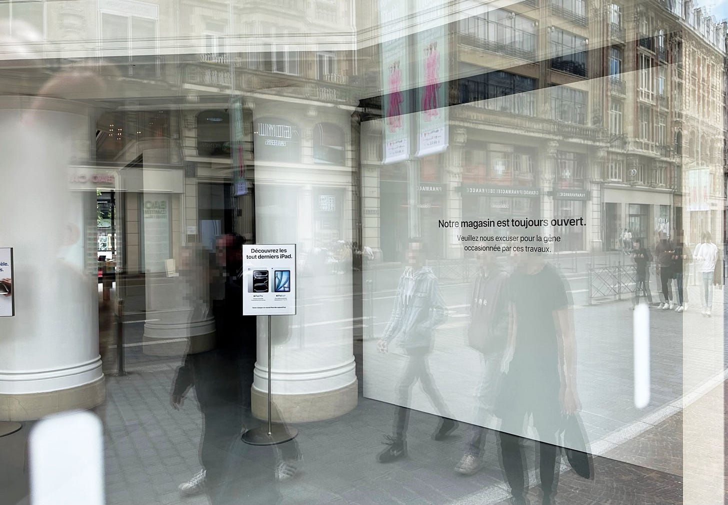 A photo taken through the window at Apple Lille. One portion of the store has been blocked by a white barricade. A photo taken through the window at Apple Lille. One portion of the store has been blocked by a white barricade.