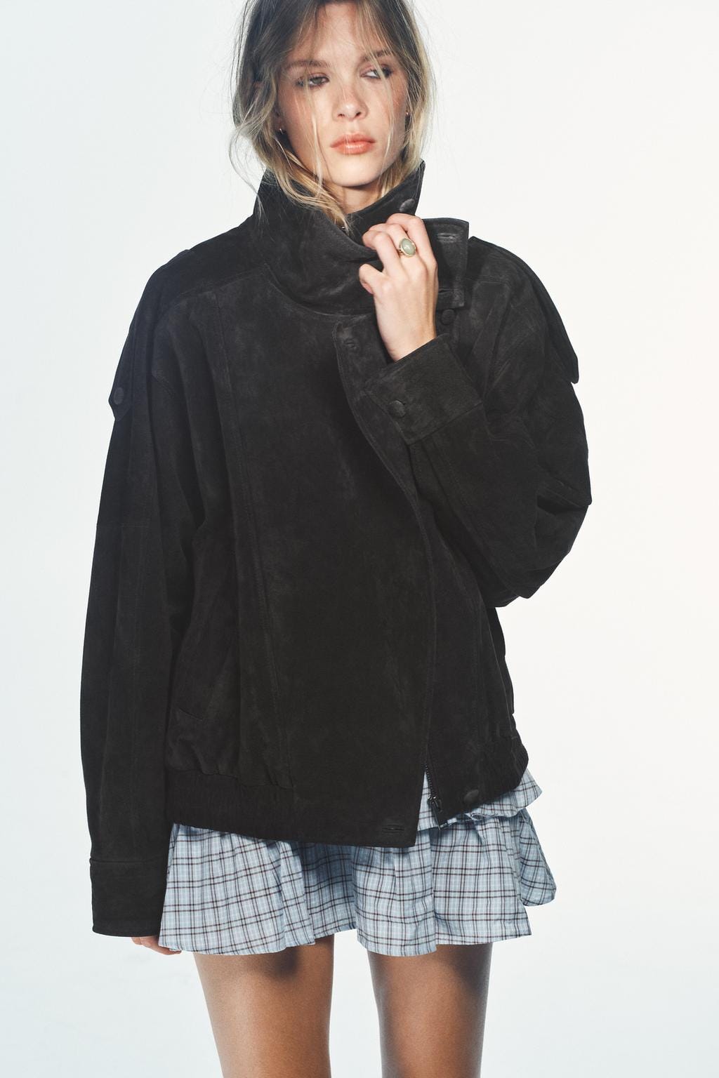 Black high-neck jacket with side pockets, grey and white checked mini skirt set.