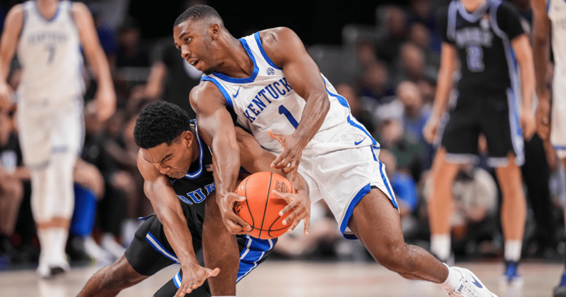 Nov 12, 2024; Atlanta, Georgia, USA; Duke Blue Devils guard Caleb Foster (1) and Kentucky Wildcats guard Lamont Butler (1) fight for a loose ball during the first half at State Farm Arena. Mandatory Credit: Dale Zanine-Imagn Images