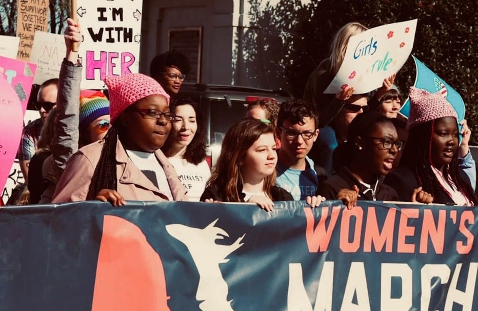 a group of people holding signs and flags