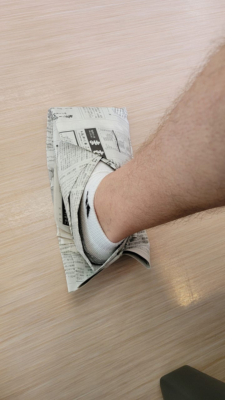 My daughter and me wearing newspaper shoes