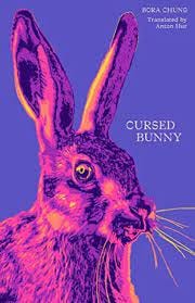 Violet background against which is the image of a horrifying pink bunny. The cover of Cursed Bunny by Bora Chung.