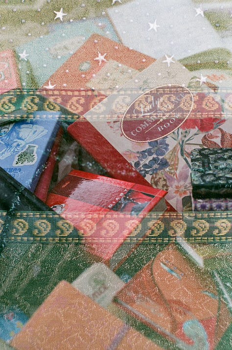 1) A black & white photograph of a photograph, which contains a large sign on the side of the road reading: "HELLO STRANGER" in capital letters. 2) A scattered pile of multi-coloured books overlayed with sheer, green pattered cloth. 3) A black & white photograph of café chairs & tables crammed against a wall. 4) Scattered, multi-coloured books. 5) A black & white photograph of a wooden deck in an alleyway. Lights are strung across both the deck & alleyway. 6) An ink drawing of a map of a fantasy land. 7) A black & white photograph of two chairs & a table next to a window. A neon sign reading "coffee" is above them. 8) A black, mauve, and dark green watercolour painting of a bare forest. Beneath the painting are the words "magic forest" in calligraphy. 9) A black & white photograph of the roof of an ornate building, mirroring itself at the top & bottom of the image.