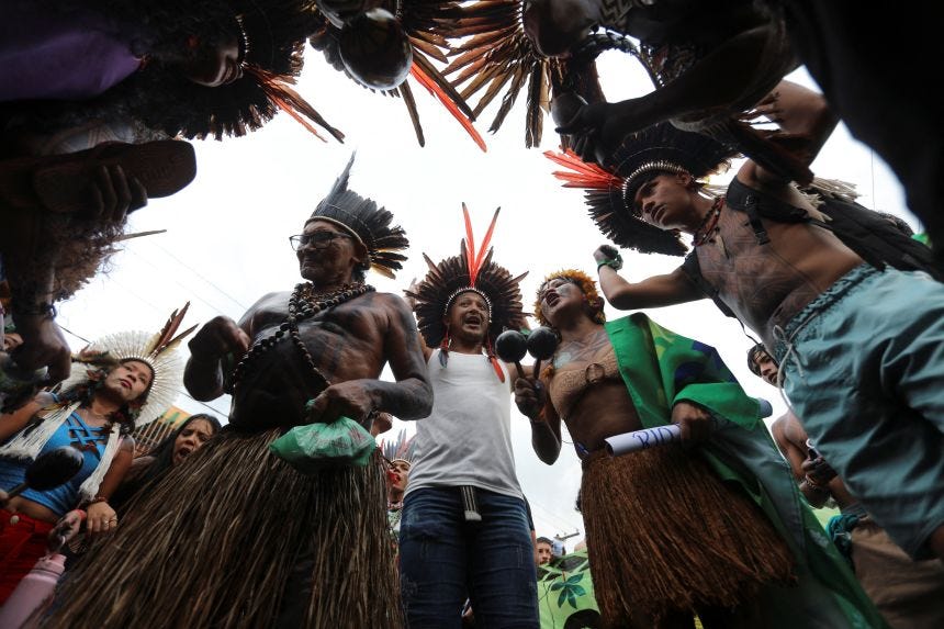 Indigenous demonstrators gather outside the venue hosting the UN Climate Change Conference (COP30), in Belem, Brazil, on November 11, 2025.