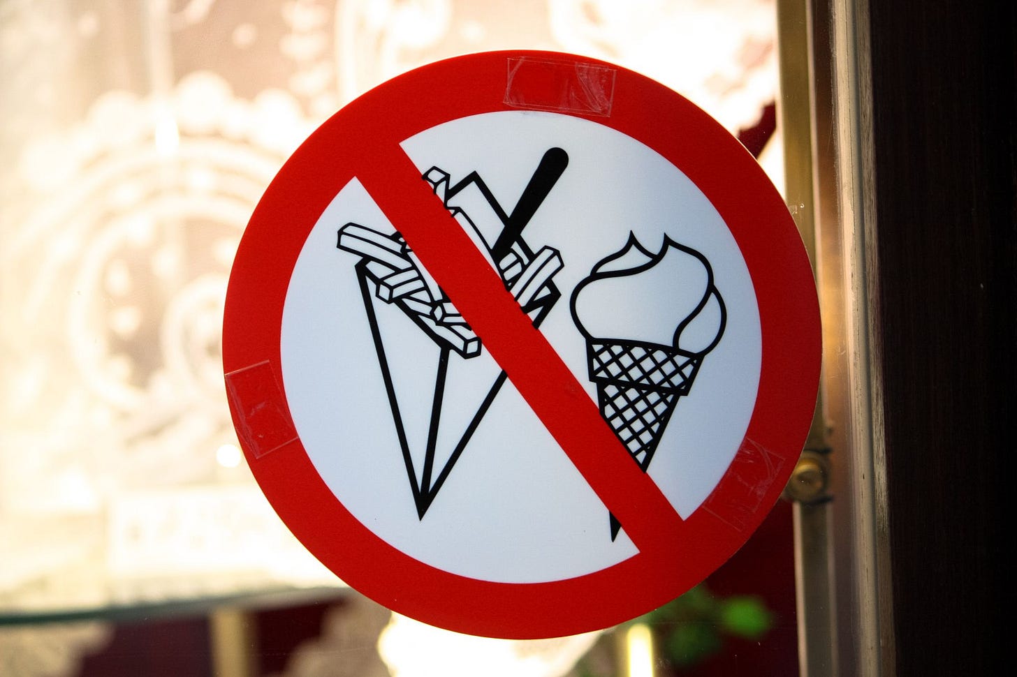A red "banned" sign with ice cream and French fries