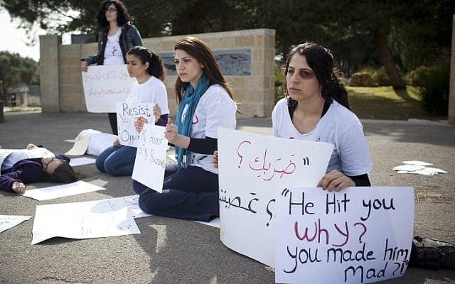 Jewish and Arab women silently protest domestic violence at Hebrew University in Jerusalem on March 8, International Women's Day (photo credit: Yonatan Sindel/Flash90)