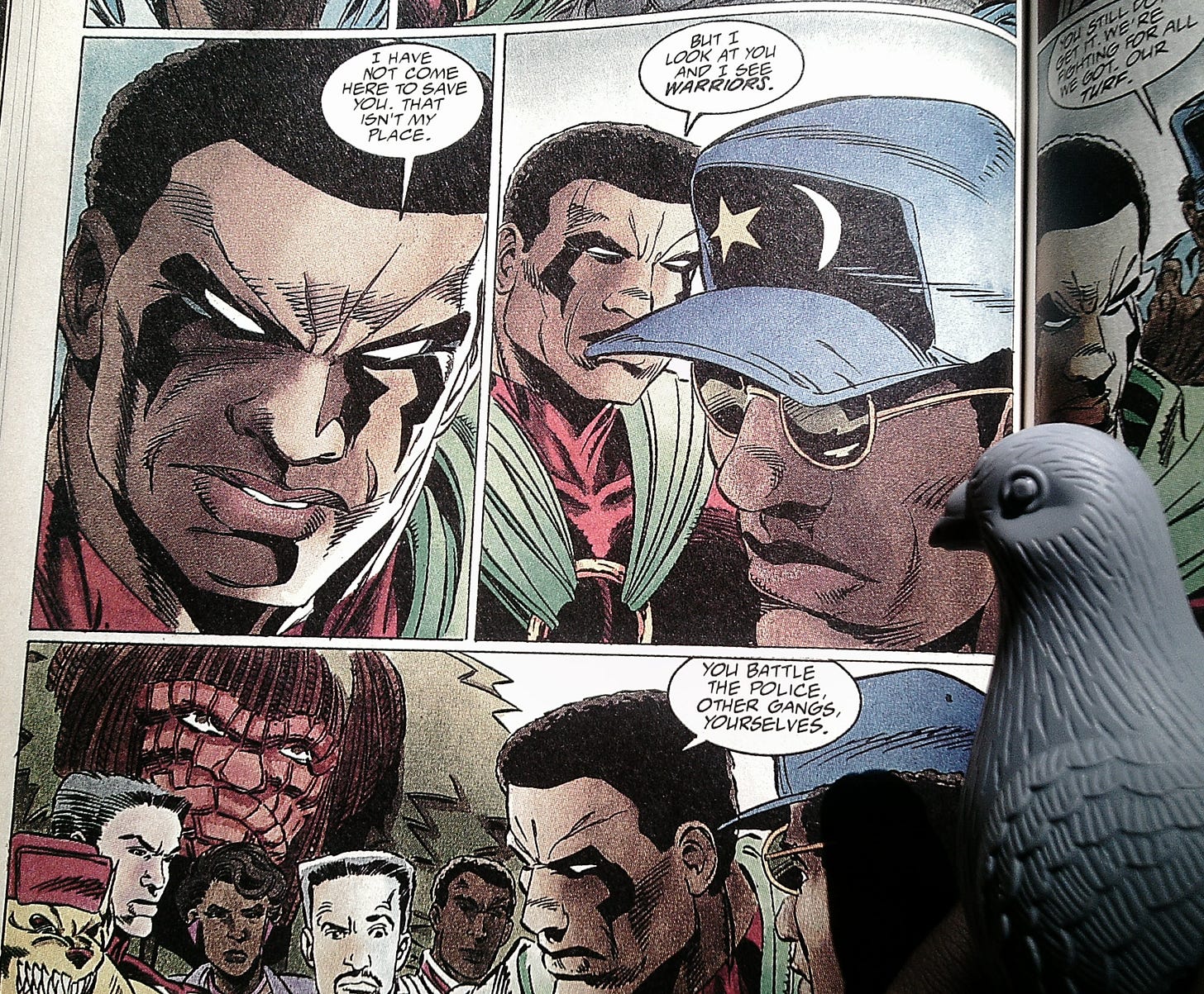 Icon tells some "Big Bang" survivors: ""I have not here to save you. That isn't my place. But I look at you and I see warriors. You batle the police, other gangs, yourselves." CB pigeon figurine looks on at bottom right. Icon tells some "Big Bang" survivors: ""I have not here to save you. That isn't my place. But I look at you and I see warriors. You batle the police, other gangs, yourselves." CB pigeon figurine looks on at bottom right.