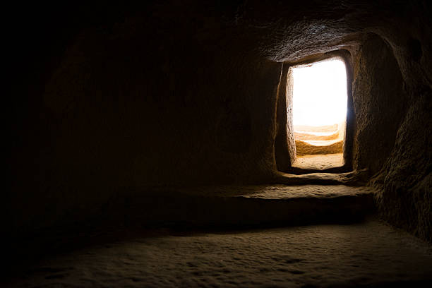 Doorway to light Bright sunlight outside the entrance to a room carved from stone centuries ago at Keşlik Monastery, in Turkey's Cappadocia region. open tomb stock pictures, royalty-free photos & images