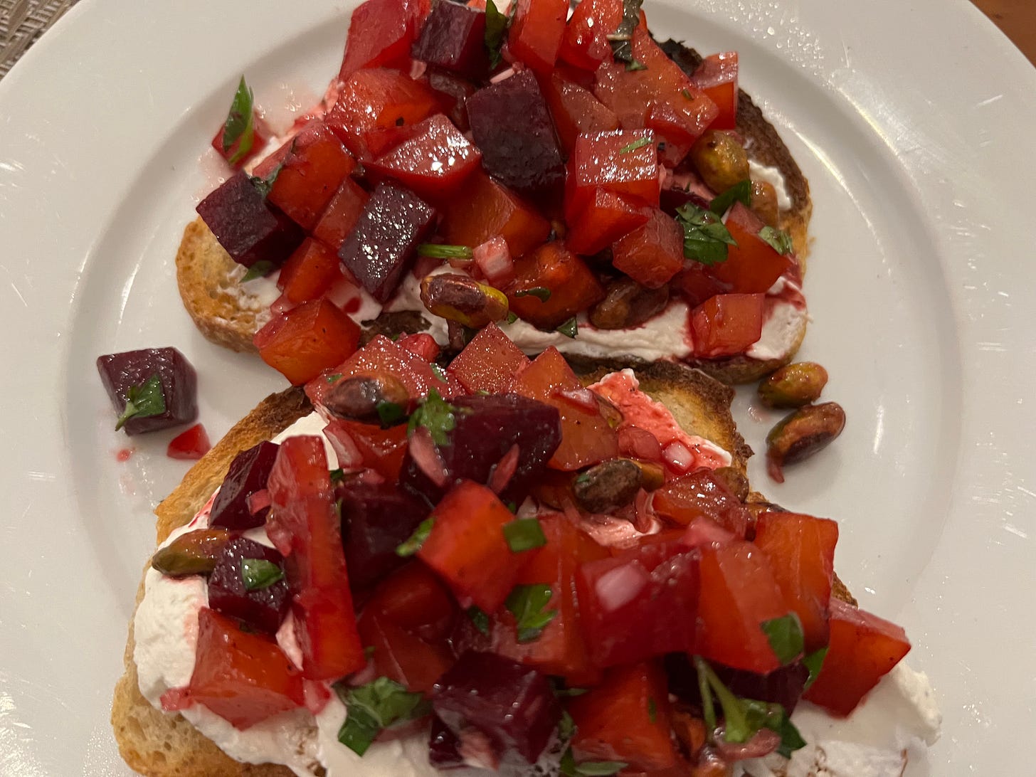 white plate with beet toast and goat cheese
