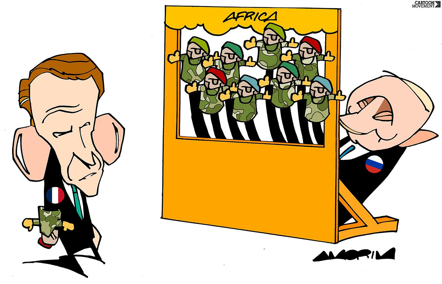 Cartoon showing Putin with eight arms playing hand puppets dressed as military generals in a puppet theater labeled 'Africa' while Macron is watching.
