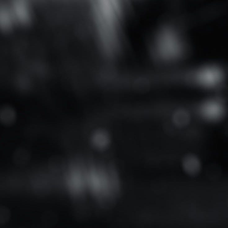 This may contain: a blurry black and white photo of some lights