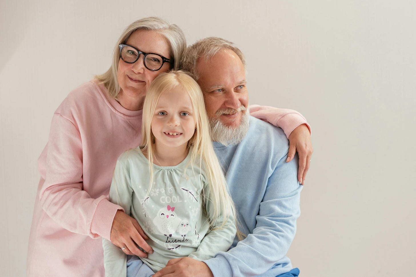 A child sitting with their grandparents