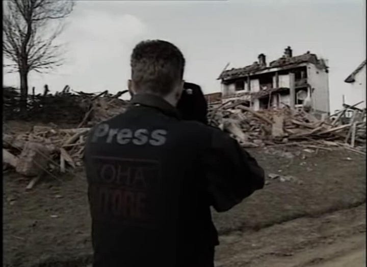 (First Image – Alban Bujari at Work) Alban Bujari, one of Kosovo’s first war photojournalists, documents the destruction of civilian homes during the Kosovo War (1998-1999). His work remains a crucial testimony to the crimes committed during the conflict. (Second Image – Alban Bujari in the Field) A rare image of Alban Bujari in action, capturing the horrors of war while providing vital documentation of Kosovo’s suffering. His camera was a weapon of truth in one of Europe’s most brutal conflicts of the late 20th century.