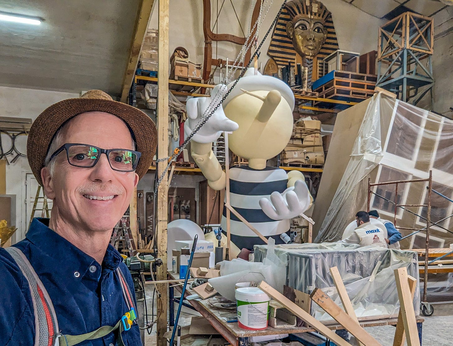Michael standing in front of a very large Pinocchio ninot. 