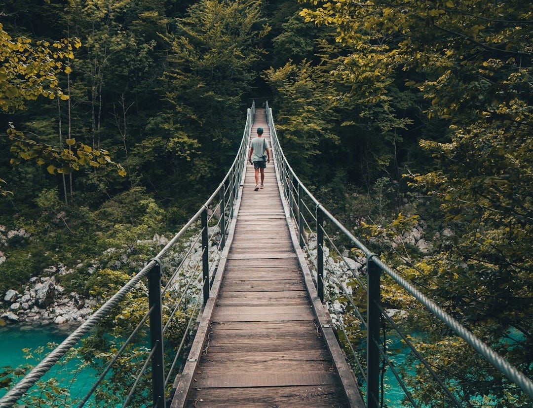 person walking on bridge person walking on bridge