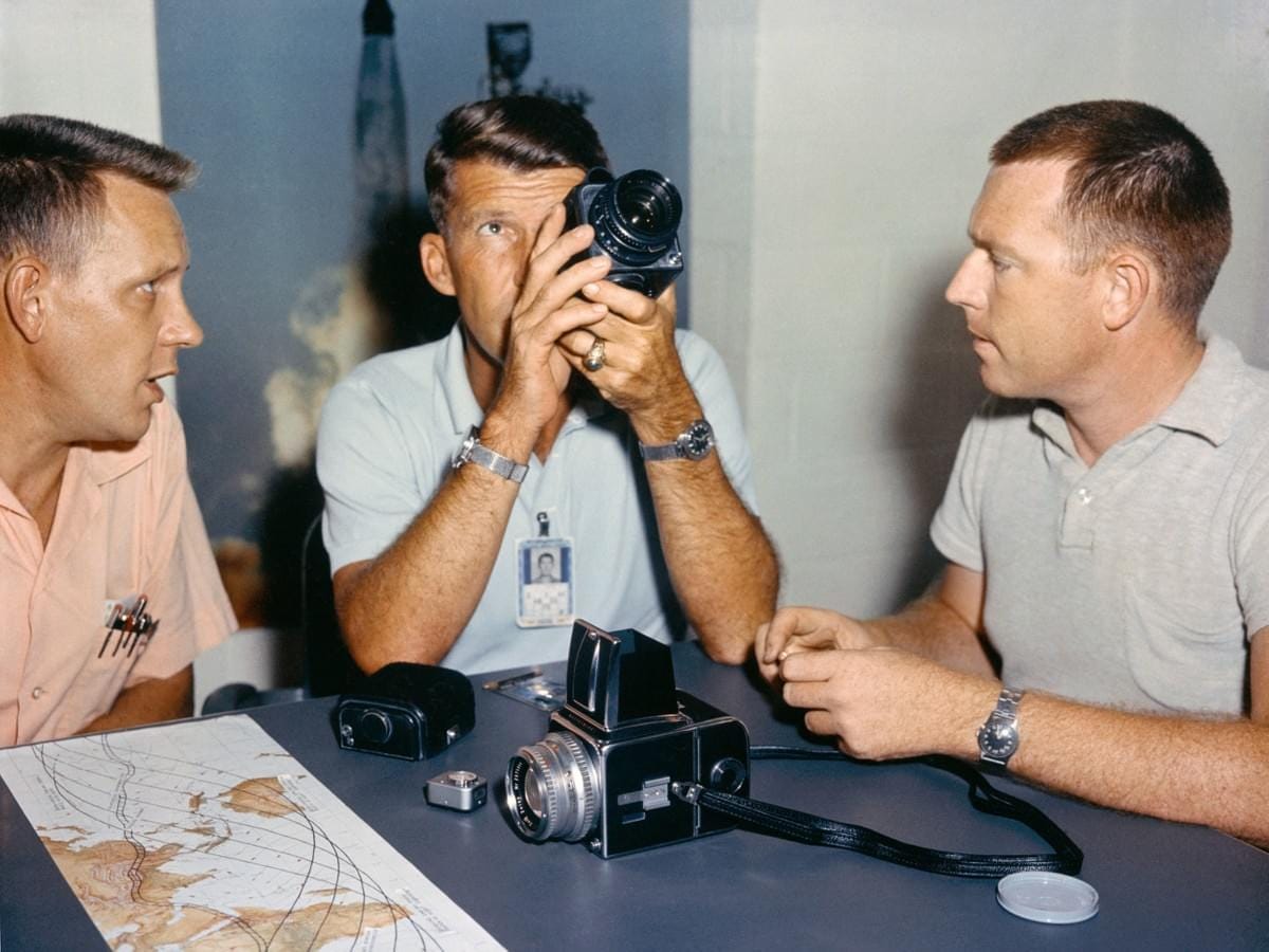 Astronaut Walter Schirra, center, checks out his spacecraft's camera equipment with Paul Becker of McDonnell, left, and Roland Williams of RCA. Astronaut Walter Schirra, center, checks out his spacecraft's camera equipment with Paul Becker of McDonnell, left, and Roland Williams of RCA.