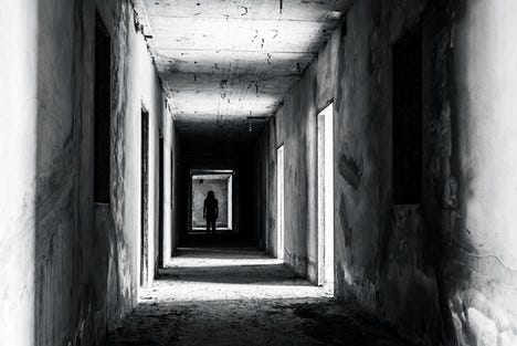 Shadowy, decripit hallway with a person silhouted at the far end. black and white and spooky. Shadowy, decripit hallway with a person silhouted at the far end. black and white and spooky.