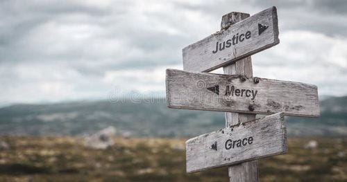 Justice mercy grace text engraved on wooden signpost outdoors in nature. Panorama format. Grace stock images, royalty-free photos and pictures