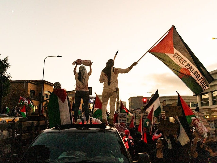a group of people standing on top of a truck