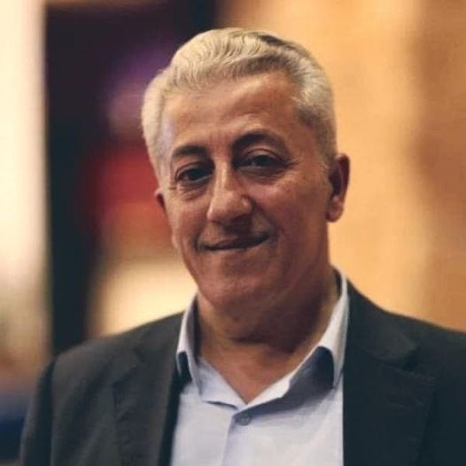 A person in a suit

Description automatically generated