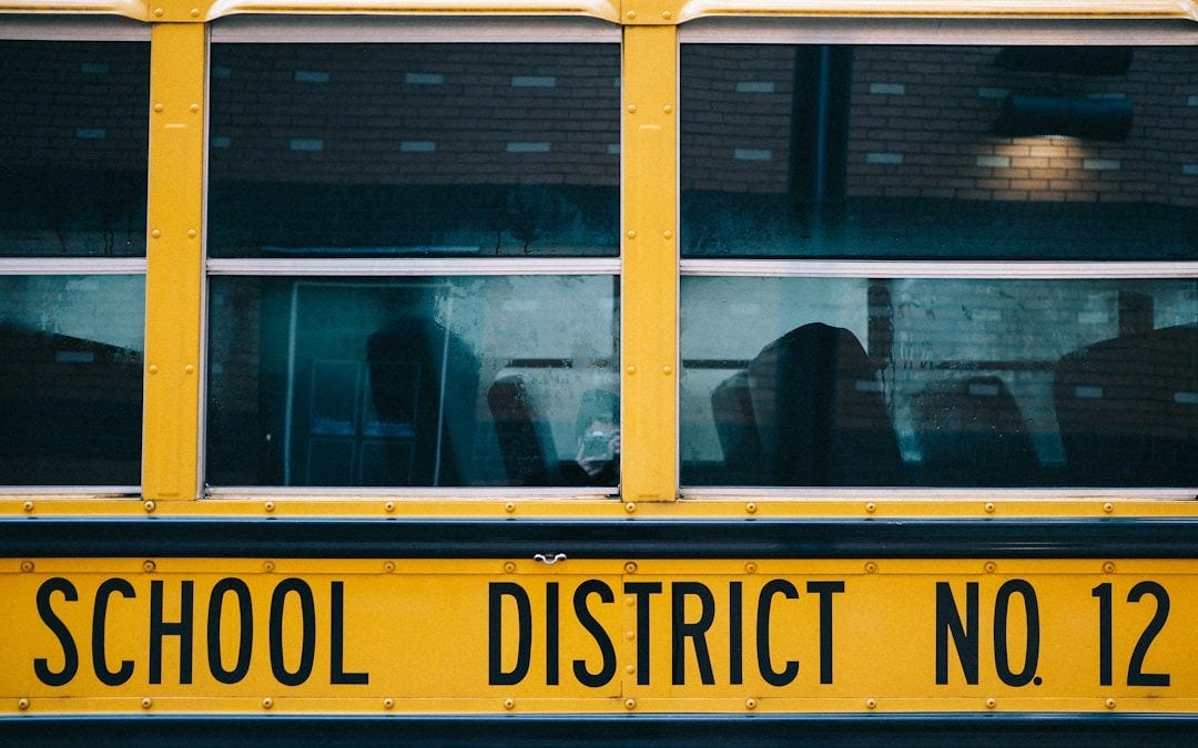 yellow school bus in front of building yellow school bus in front of building