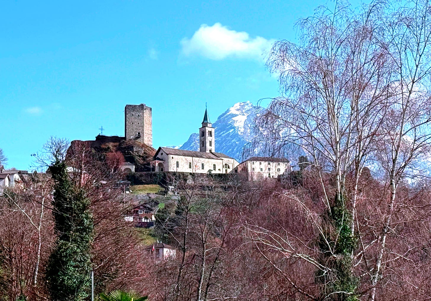 Church on hillside with towering mountain behind Church on hillside with towering mountain behind