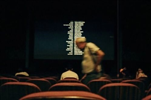 This may contain: people sitting in an auditorium watching a movie