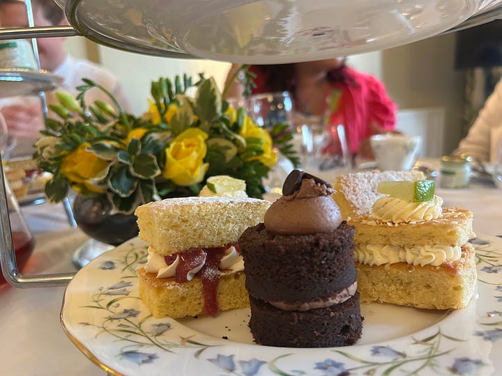 Cakes on a cakestand and a table laid out for guests at Petwood Hotel, Woodhall Spa