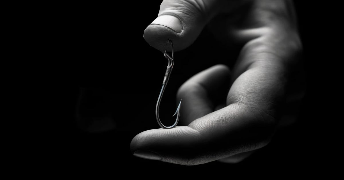 Hand holding a hook, set in black background.