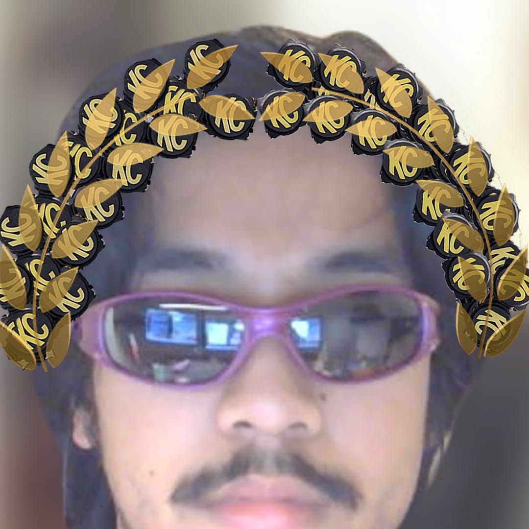 A self-portrait depicting a blurry selfie of me with a neutral expression wearing purple sunglasses. Edited atop my head is a laurel wreath.