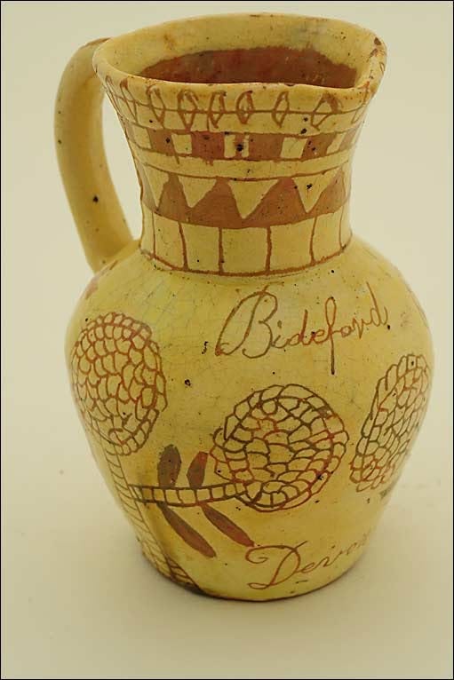 This may contain: a vase with writing on it sitting on a table This may contain: a vase with writing on it sitting on a table