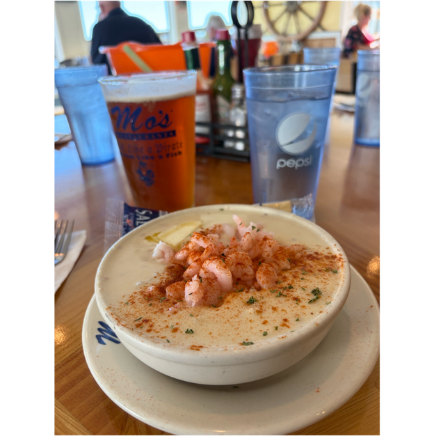 A bowl of soup with shrimp and spices on a table

AI-generated content may be incorrect.