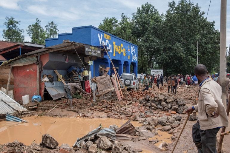 Residents salvage their household items after their homes were swamped following rains