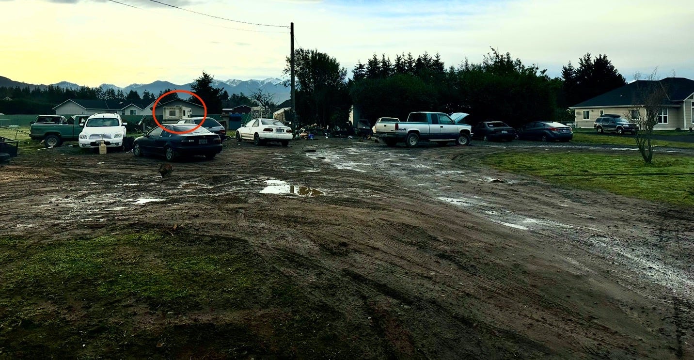 A group of cars parked in a muddy lot

Description automatically generated