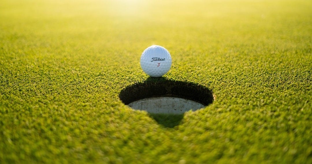 golf ball on green grass field during daytime golf ball on green grass field during daytime