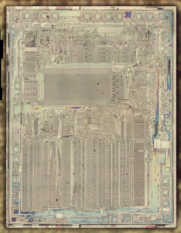 Die photo of the 8087 coprocessor with the metal layer stripped off to reveal the silicon underneath. Patterns are visible in the silicon, the transistors that implement the circuitry,