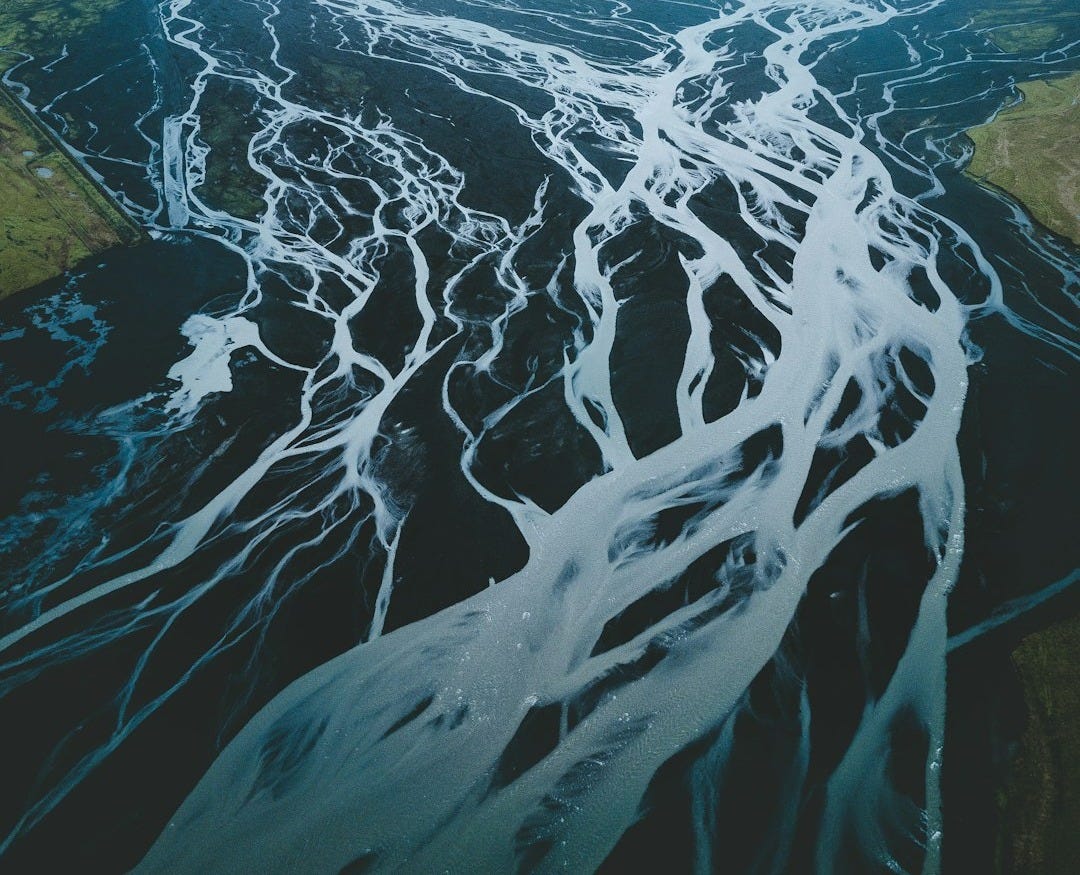 mountain surrounded with body of water