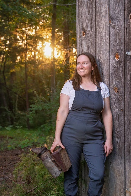 beekeeper Tara Lynne Groth holding a bee smoker
