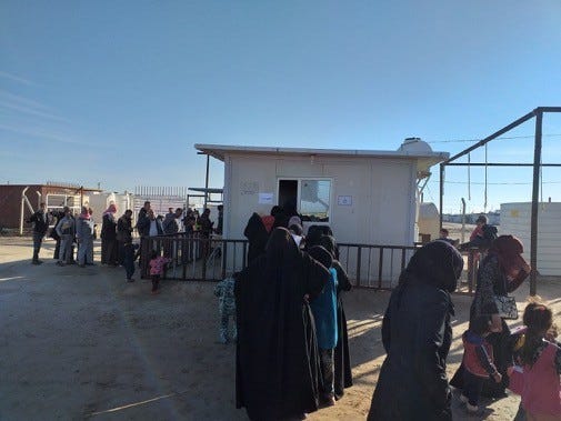 A group of people standing in front of a building

AI-generated content may be incorrect.