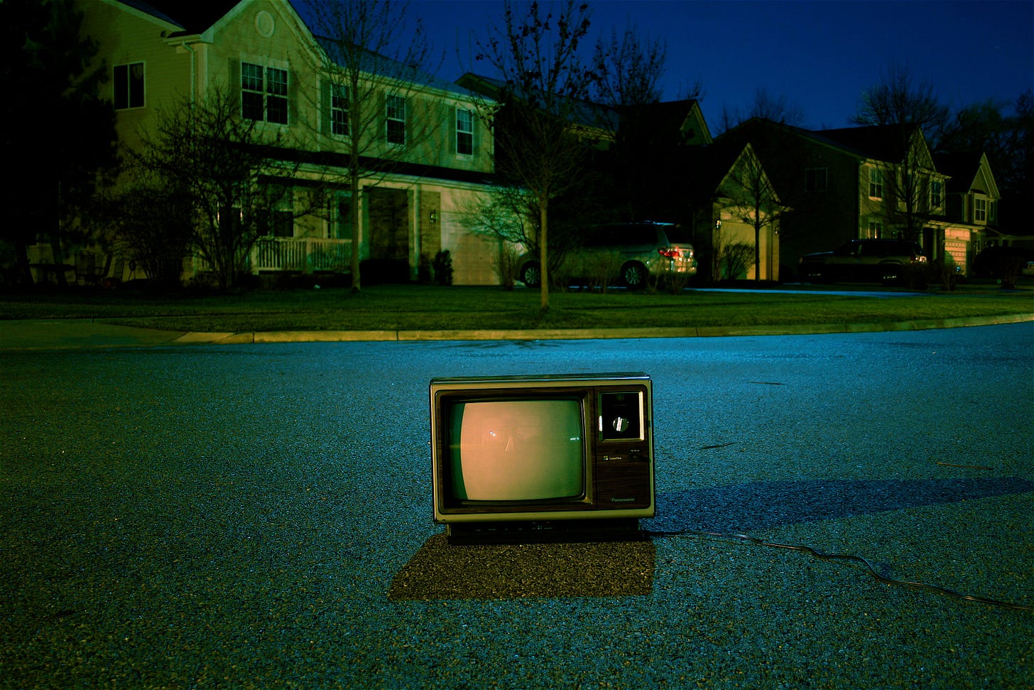 Vintage television set sitting alone in a quiet suburban street at night, symbolizing how television shaped Generation X before social media algorithms and smartphones. Vintage television set sitting alone in a quiet suburban street at night, symbolizing how television shaped Generation X before social media algorithms and smartphones.
