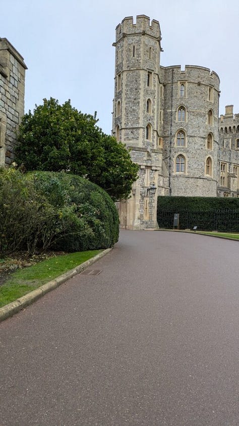 The first image shows a traditional British afternoon tea setup with tiered trays of scones, sandwiches, pastries, and desserts, along with a teapot and teacup on a floral-patterned table setting in a cozy café. The second image depicts a stone pathway leading toward the entrance of a grand historic castle tower surrounded by greenery. The third image shows another view of the same castle, focusing on a large round tower with a flag on top, stone walls, and manicured lawns bordered by a rope barrier.