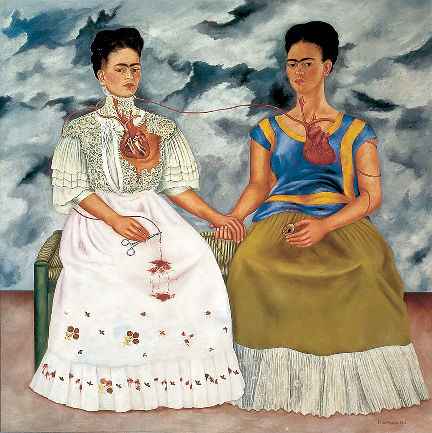 A double self portrait. Two seated women with the same face, one in a white European dress, one in Tehuana clothes, holding hands under a storm sky. A double self portrait. Two seated women with the same face, one in a white European dress, one in Tehuana clothes, holding hands under a storm sky.